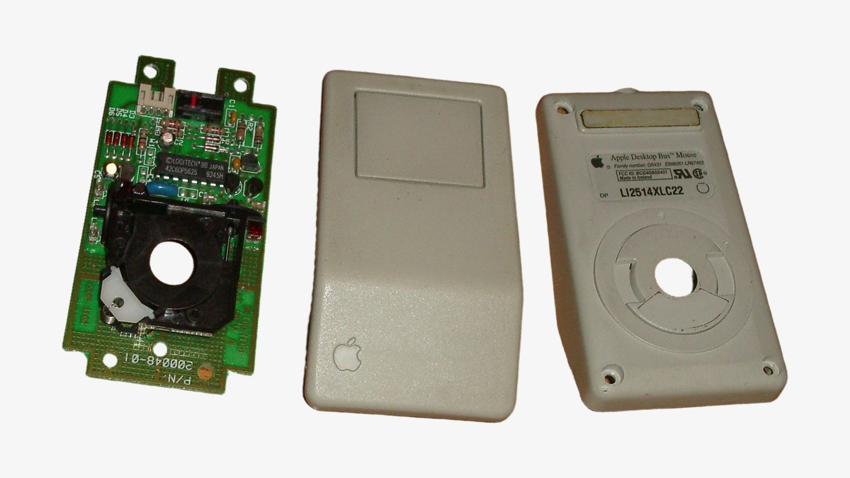 Photograph of a mouse with its upper housing, lower housing, and circuit board laid out separately